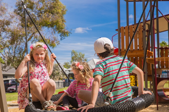 Children enjoying the all-abilities swing
