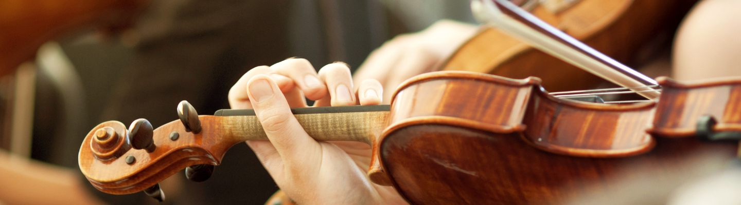 Close up of a violin being played.
