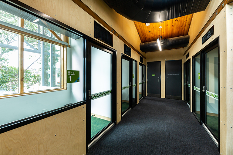 Hallway with small study rooms on either side.