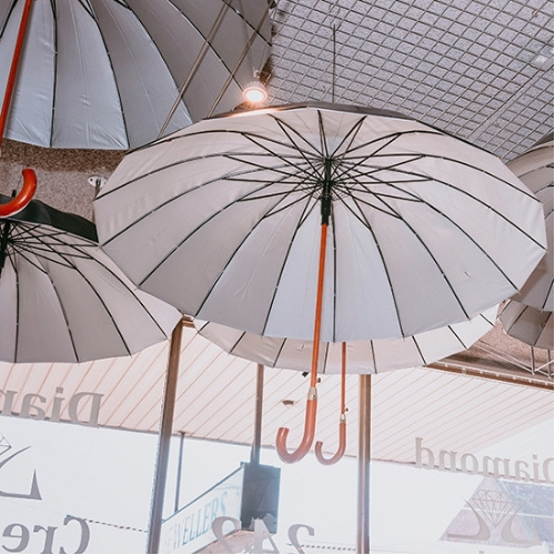 Umbrella in the window of a jewellery store.