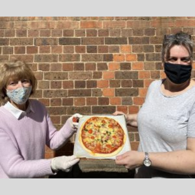 Boroondara Community Outreach volunteers with a pizza