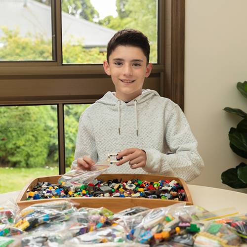 Aidan Dimitriadis behind a box of lego pieces
