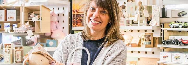 woman standing in a shop and smiling at the camera