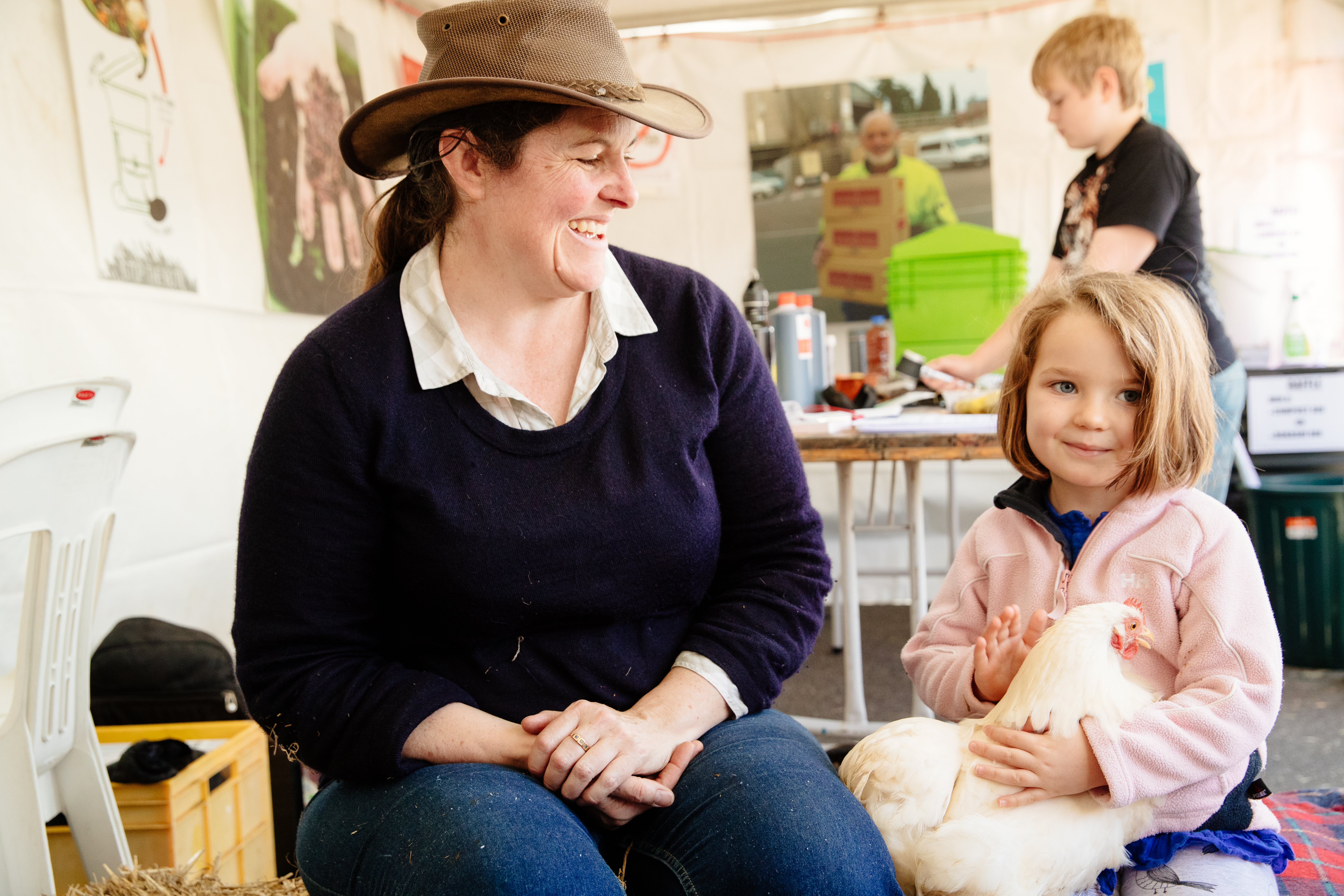 A woman and young girl with a chicken