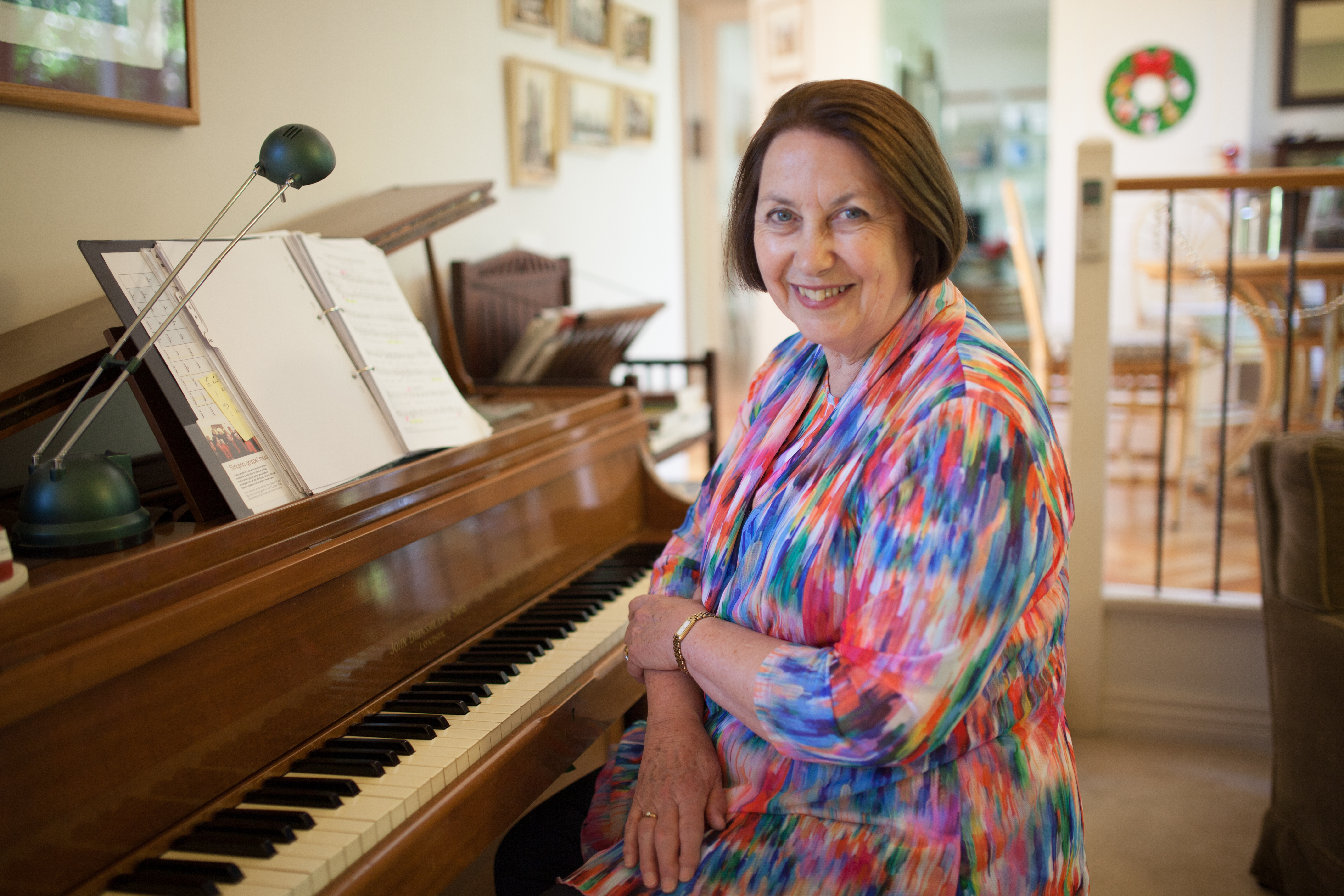 Yvonne Giltinan standing next to a piano