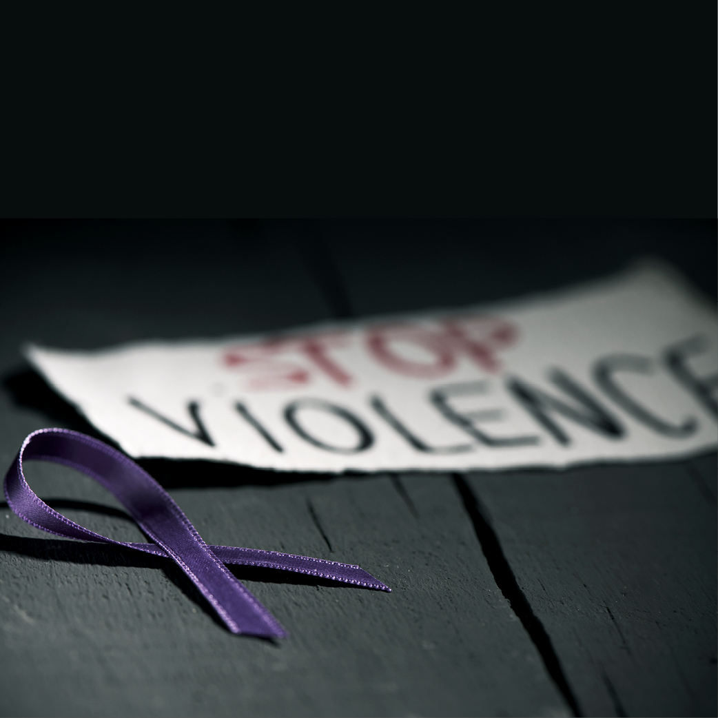 A purple ribbon and a 'stop violence' sign.
