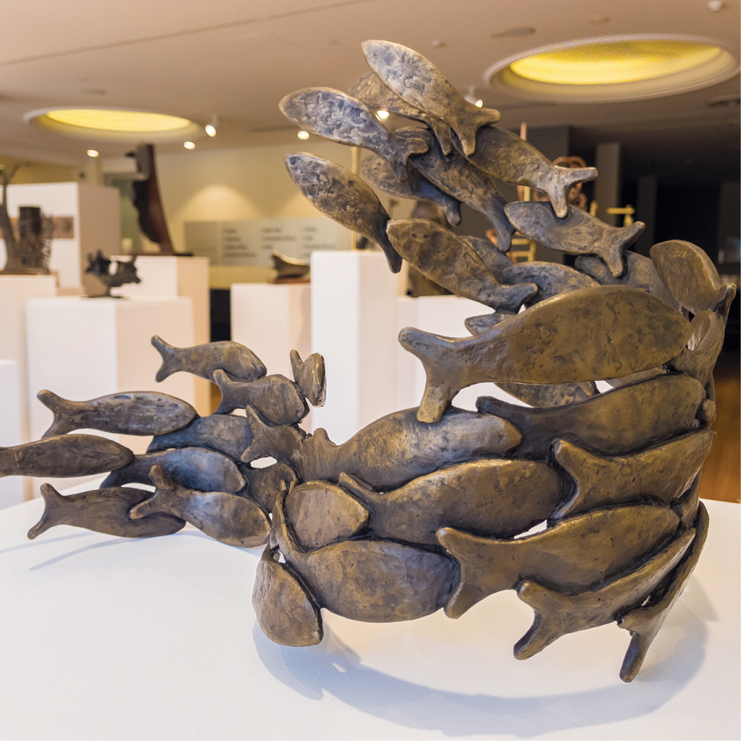 metal sculpture of a school of fish.