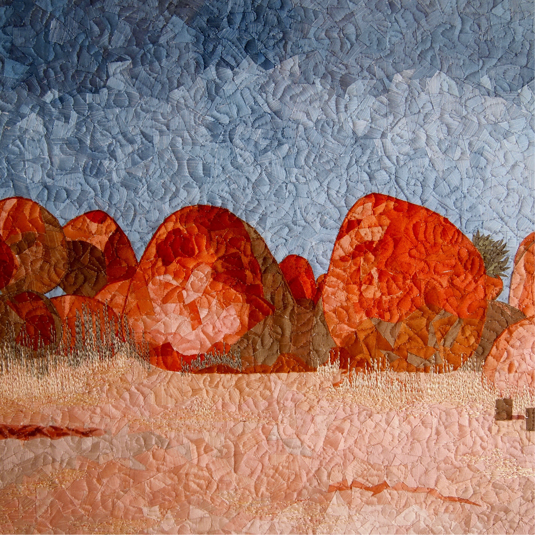 Quilted image of red boulders.