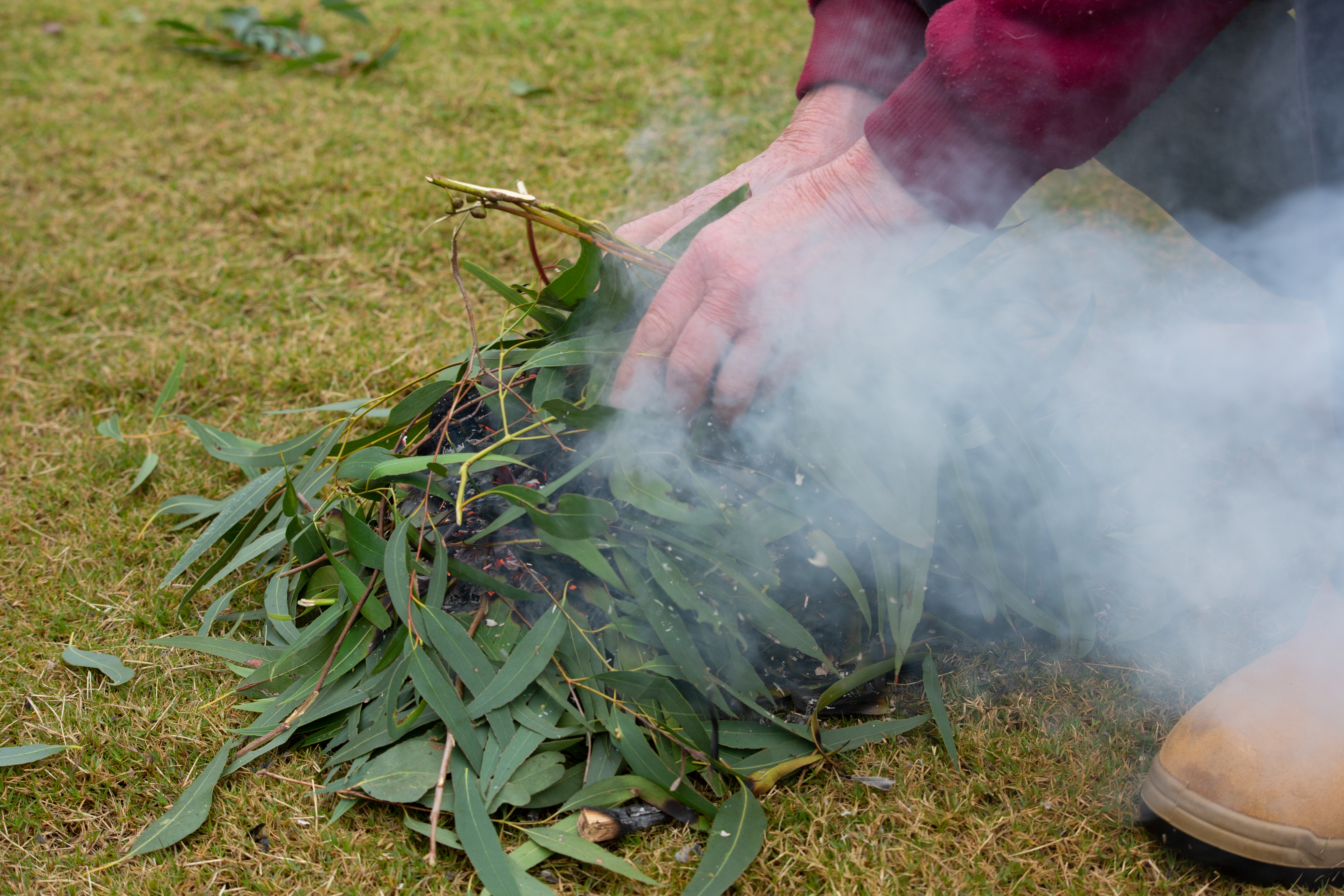A person carrying out a traditional smoking ceremony