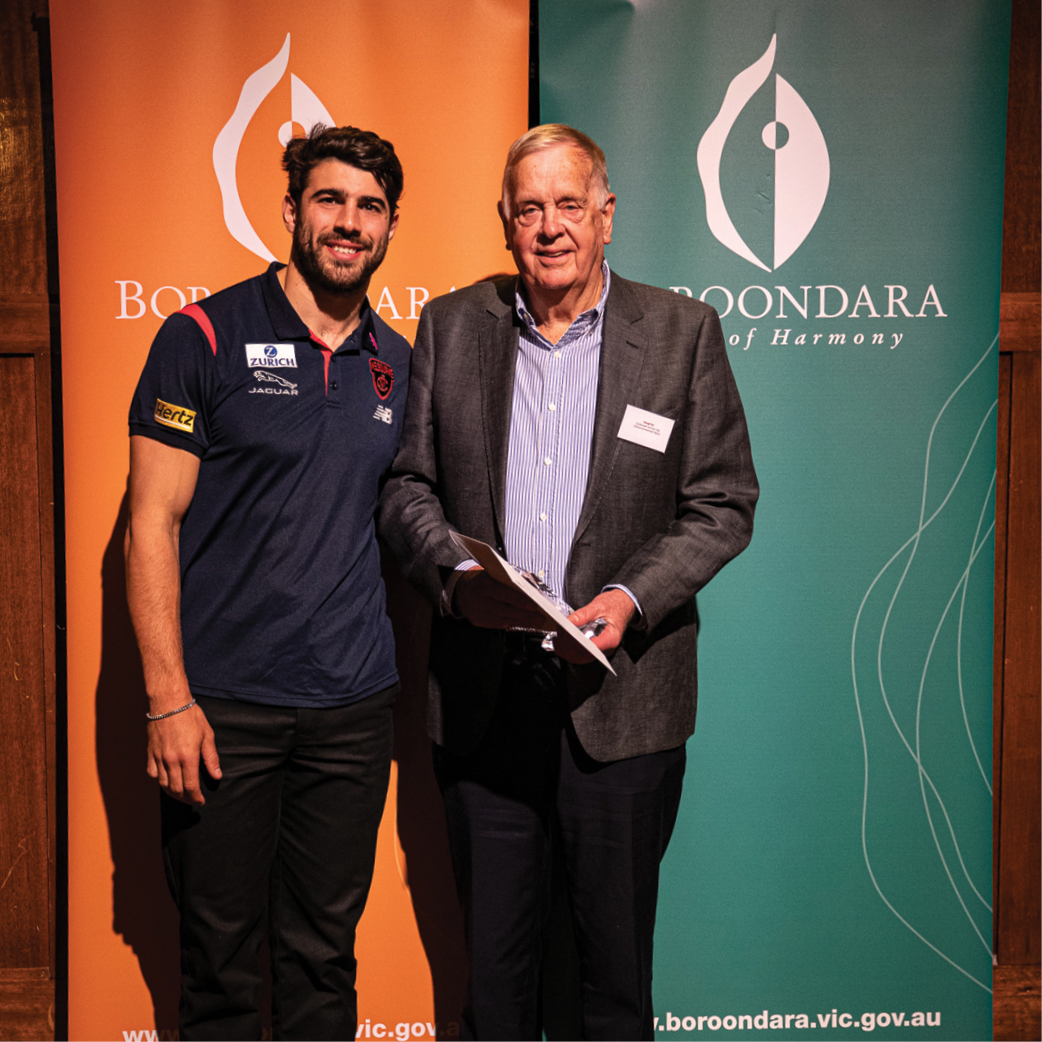 Two people at the Boroondara Sports Awards. One person is receiving their award.