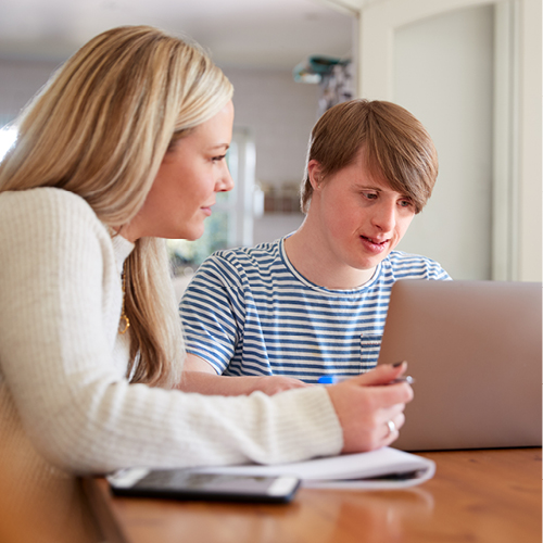 2 people using a laptop