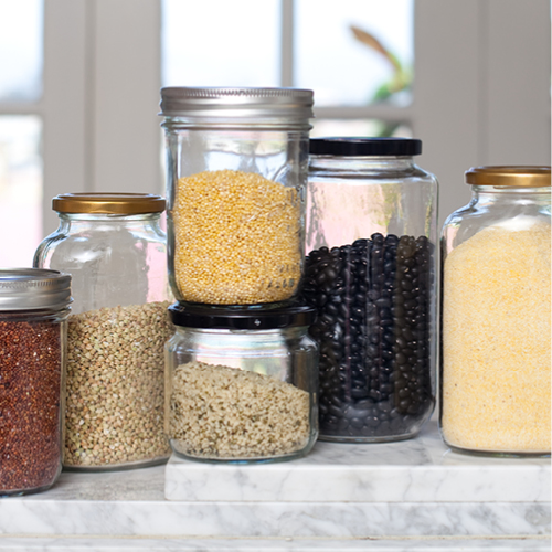 Glass containers lined up containing a range of food ingredients