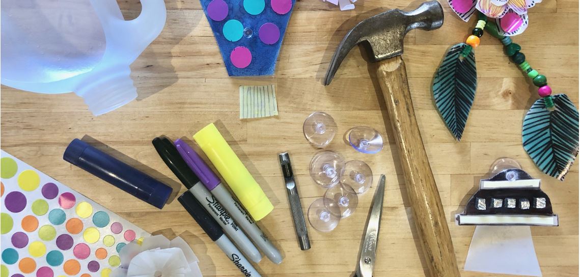 Craft tools including a hammer, stickers and scissors.
