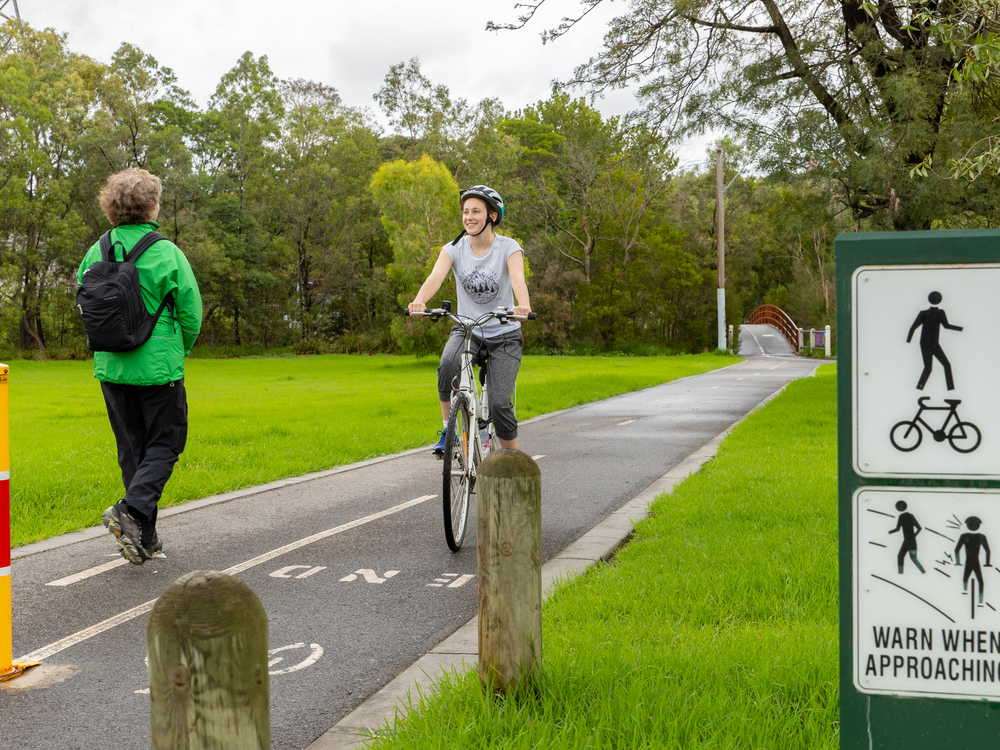 A person riding their bike along a formal shared path