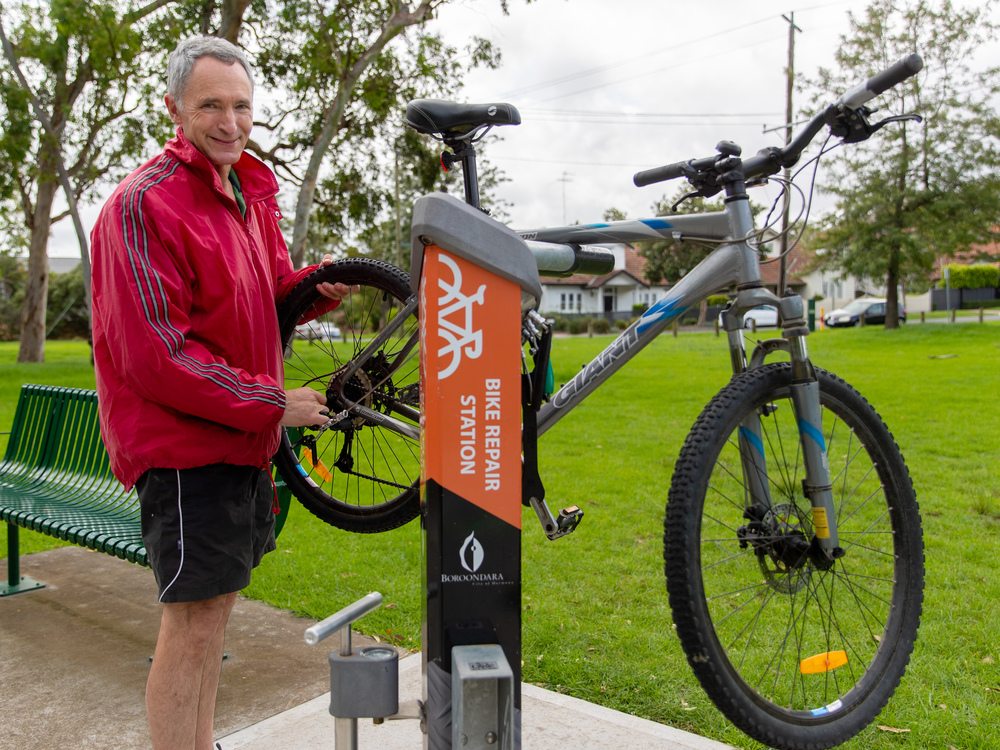 A person fixing their bike at a bike repair station