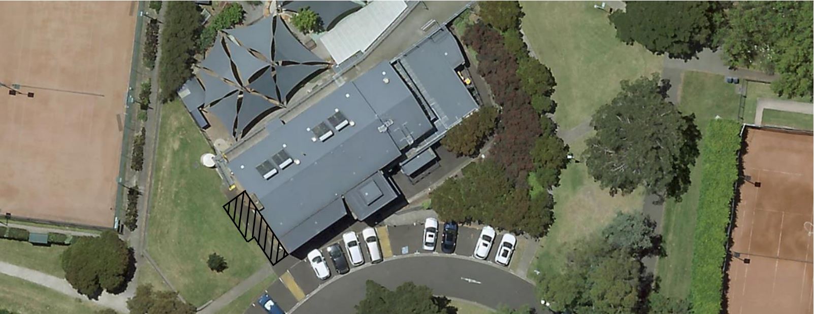 Looking down from a birds eye view on the Anderson Park Community Hub, showing a marked area to the left of the building close to the car park where the building will be extended