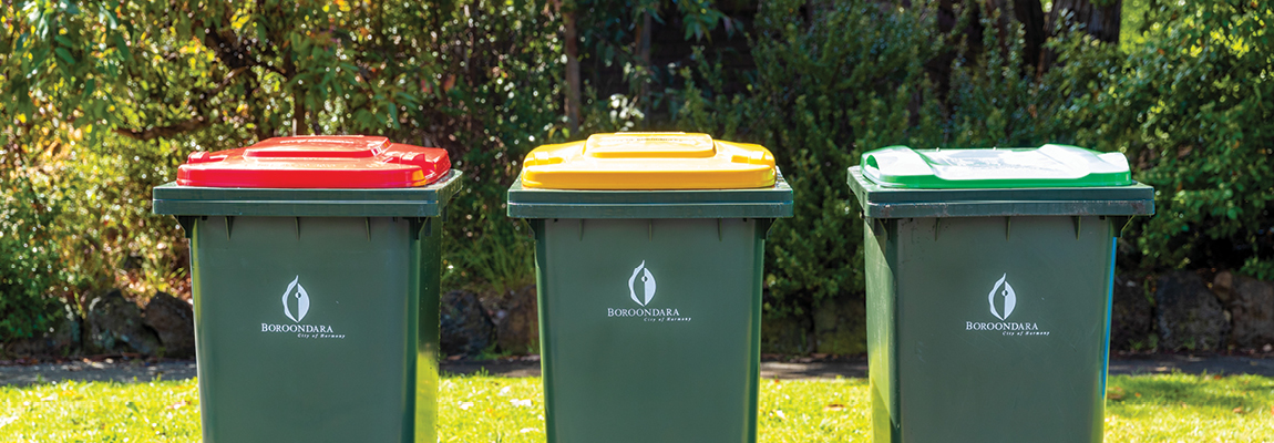 Green kerbside waste bins with red, yellow and light-green lids