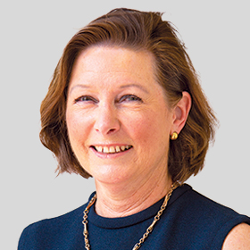 Councillor Di Gillies smiling and wearing a navy top and a necklace