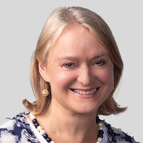 Councillor Jane Addis smiling and wearing a navy and white top and a necklace