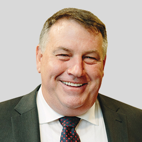 Councillor Jim Parke smiling and wearing a dark grey suit