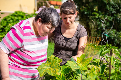 Two women gardening together