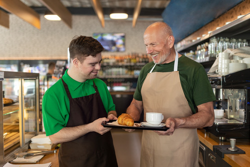 Two people working at a cafe together