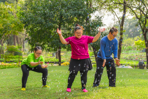 A group of people dancing in the park