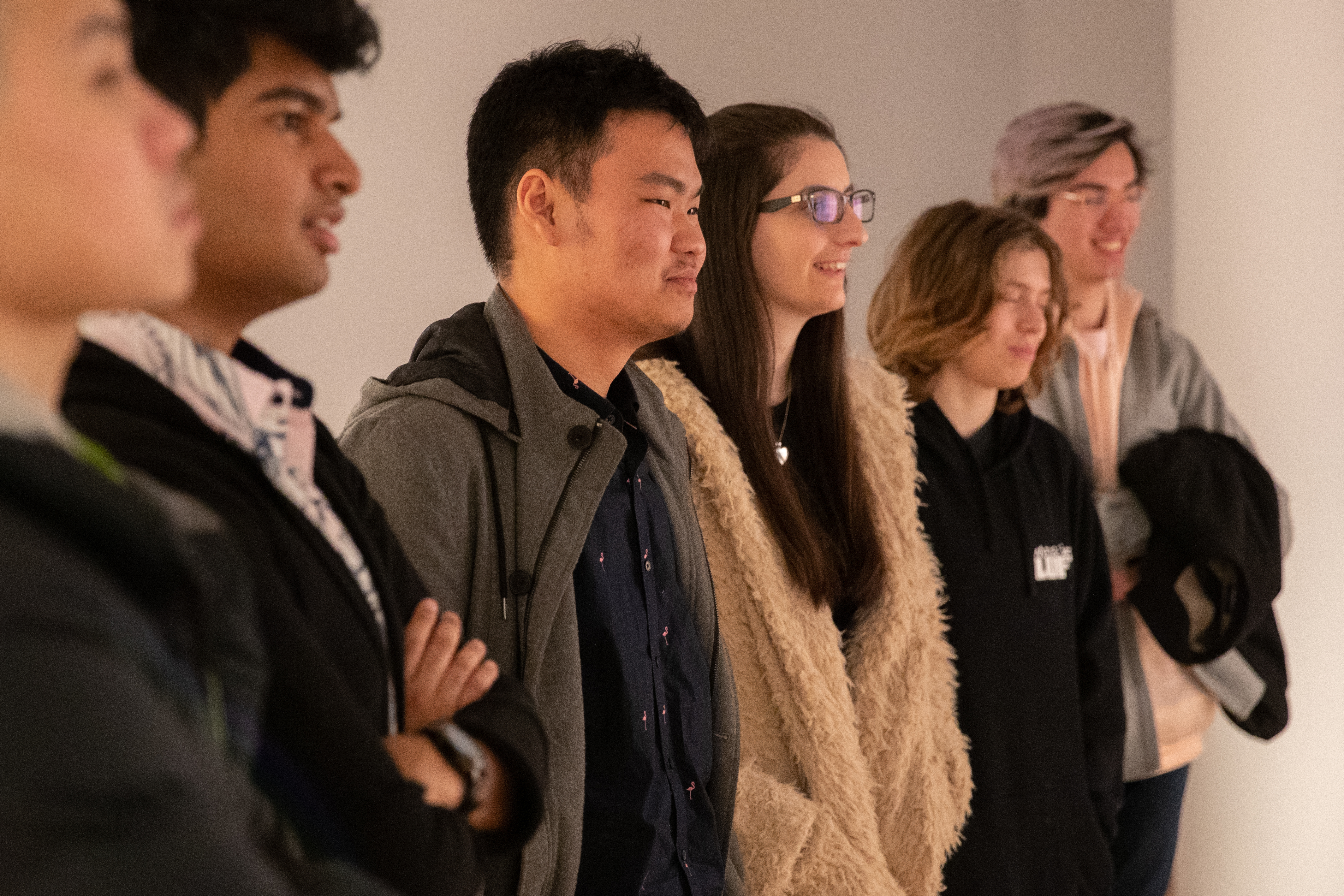 6 young people of varying skin colours in a line