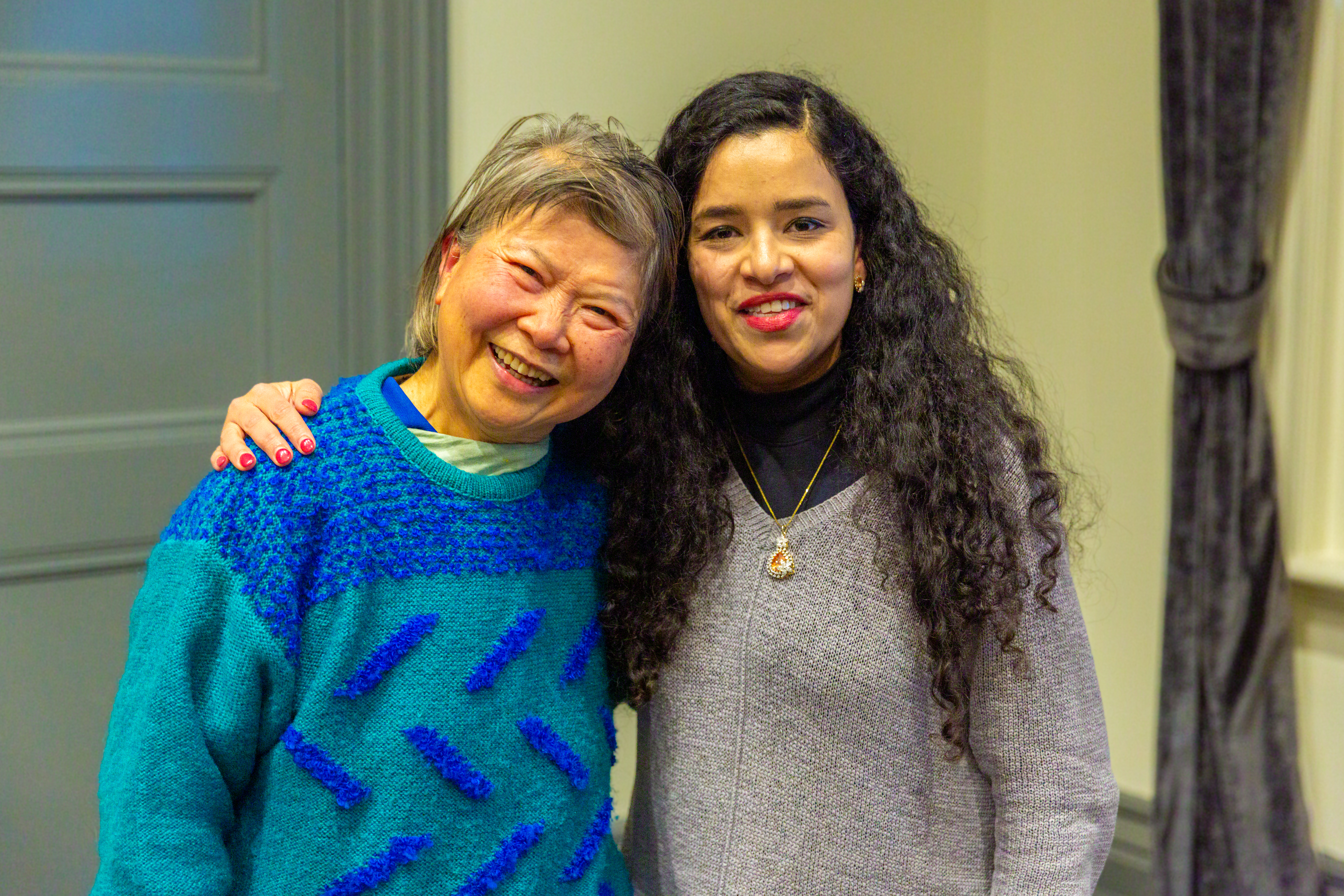 A young woman with her arm around a smiling older woman