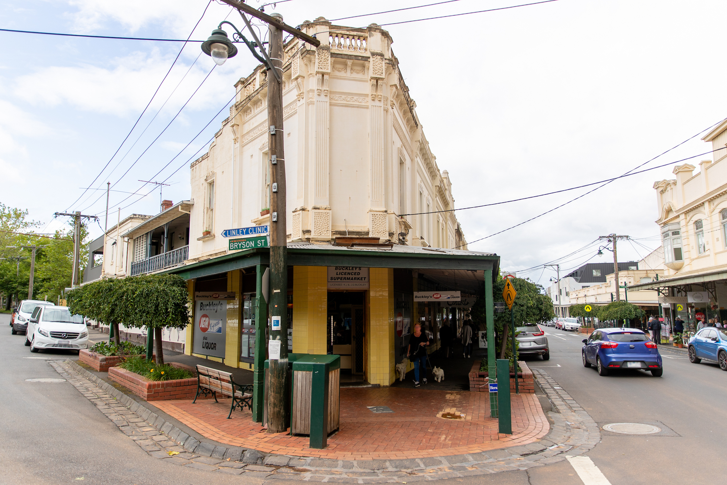 Street corner with a small shop and surrounding roads.