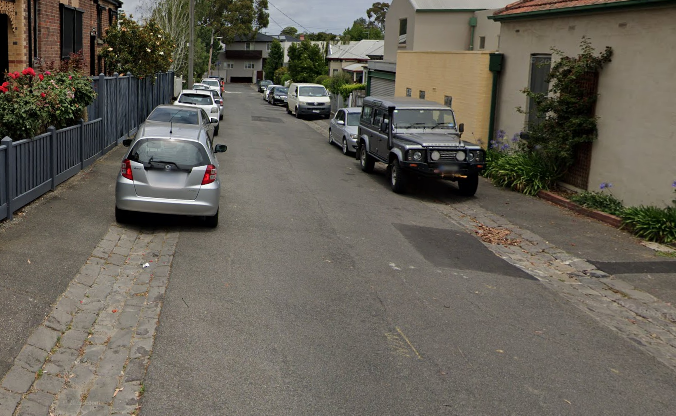 A small street with cars parked either side.