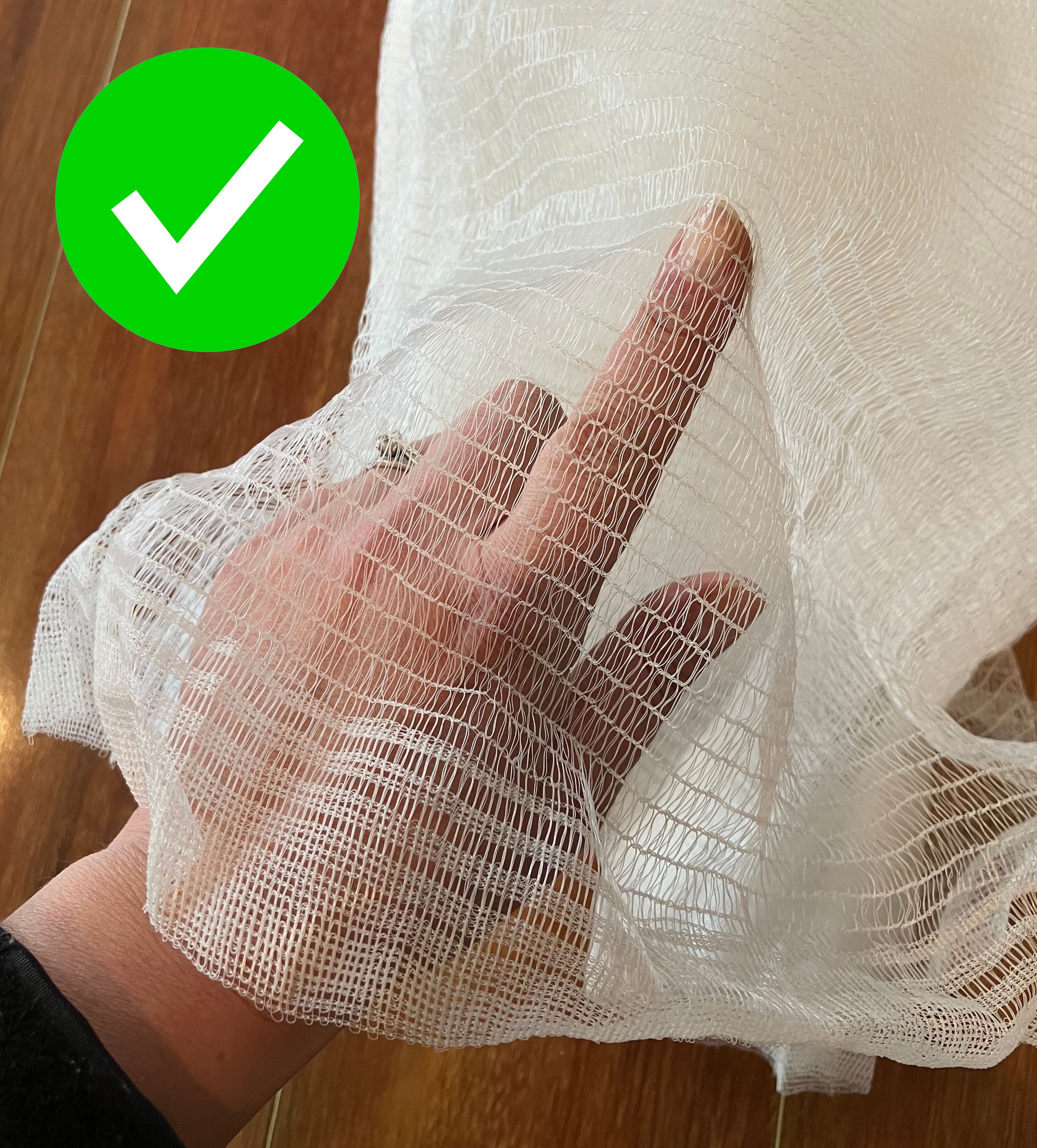 A hand holds finer netting, there is a green tick over the image. 