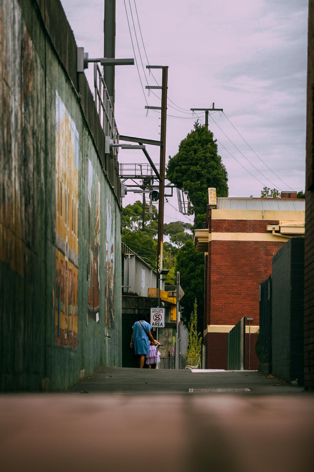 A person walking down a deserted urban street