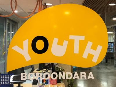 a window with a decal saying 'Youth Boroondara'