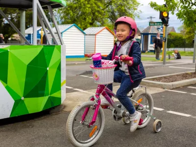 A young child riding their bike on the mini roads at Kew Traffic School