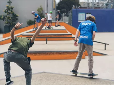 Two teenagers skateboarding in a skate park