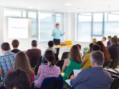 Person leading an informative session with an engaged audience.