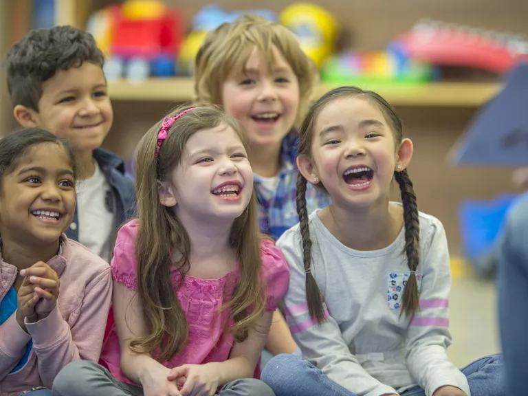 Happy kids listening to a story at the local library