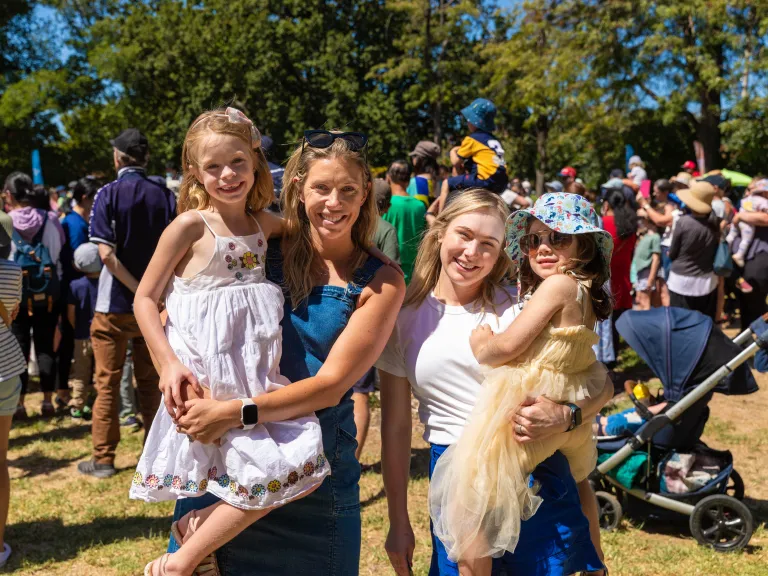 two women holding their kids at Summer in the Park