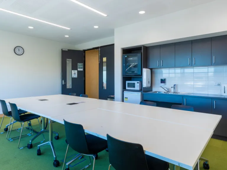 A large table takes up most of a meeting room