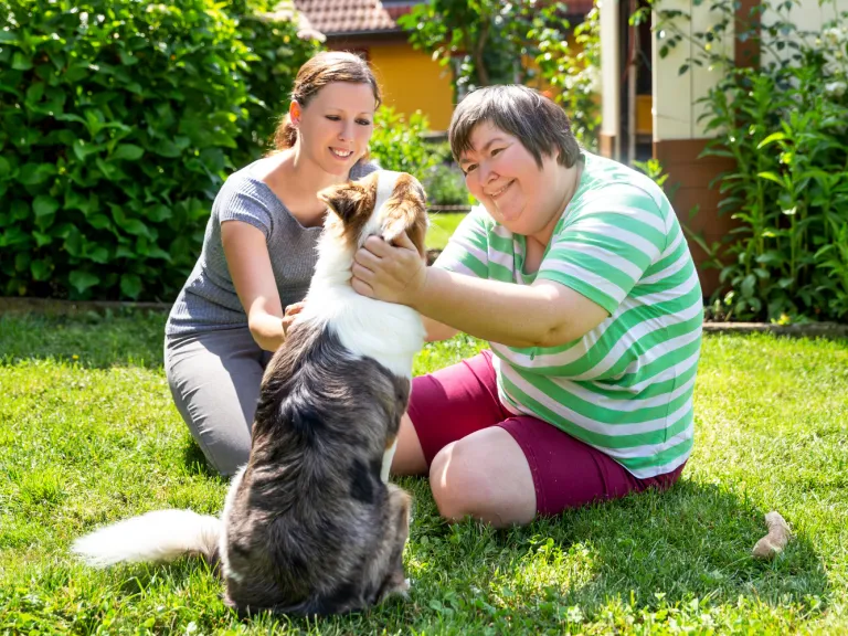 Two people outside with a dog