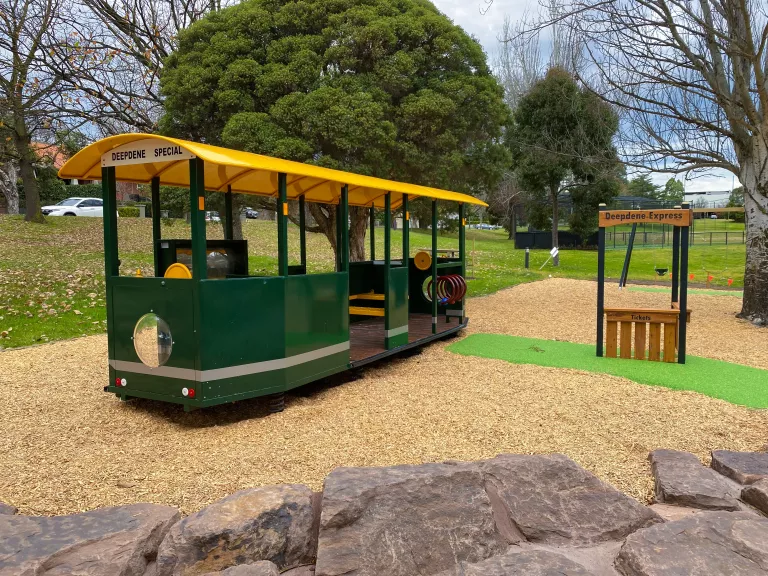 A play tram for children to play inside in a playground