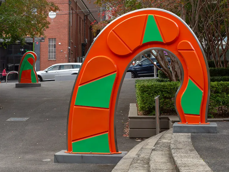 Large, abstract, orange and green public sculpture