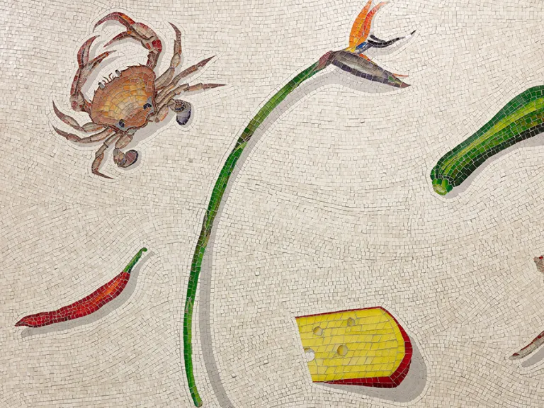 A close up photograph of a mosaic of food items on a white background.
