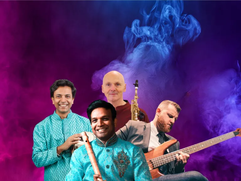 4 people against a smokey background. They are a combination of Indian and caucasian, holding traditional Indian instruments, a saxophone, and a guitar.
