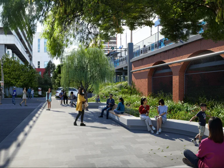 A visualisation of Columbia Street in Hawthorn. People go about their day in the area, A train can be seen in the background.