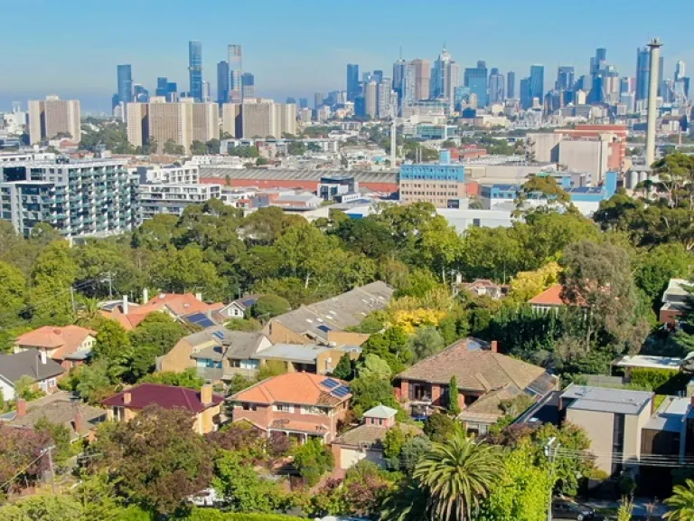Arial view looking over houses towards to the city.