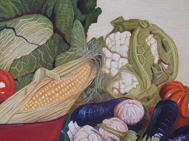 A still-life painting showing assorted vegetables arranged on a patterned, folded blue cloth. The composition includes a red bowl filled with cabbage, tomatoes, and an ear of corn, with cauliflower, eggplants, garlic, an onion, and another tomato placed beside it. 