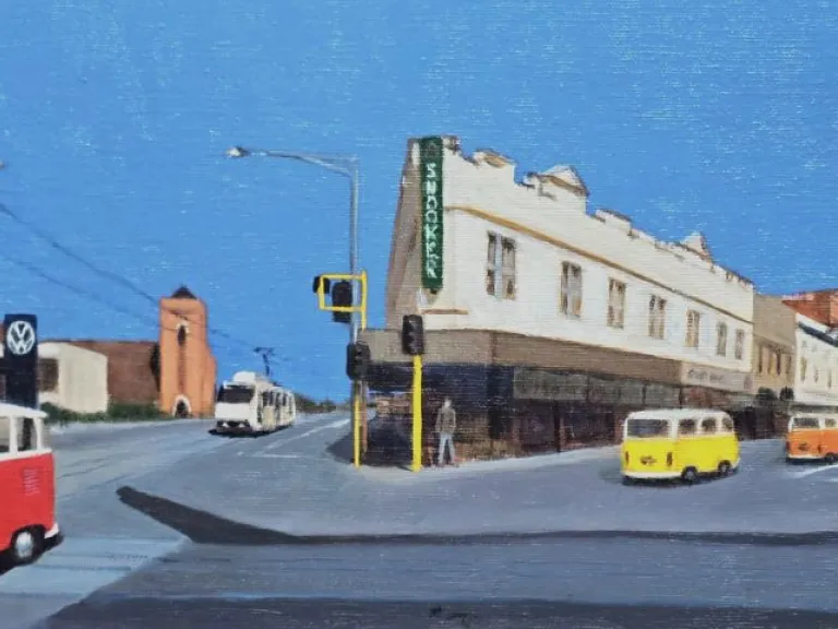 A painted street scene featuring several vintage Volkswagen vans driving through an intersection. A red-and-white van is in the foreground, with yellow, orange, and blue vans further down the road. The street is lined with older buildings, including a white corner building with a green sign, and a church-like structure on the left. The sky is bright blue.