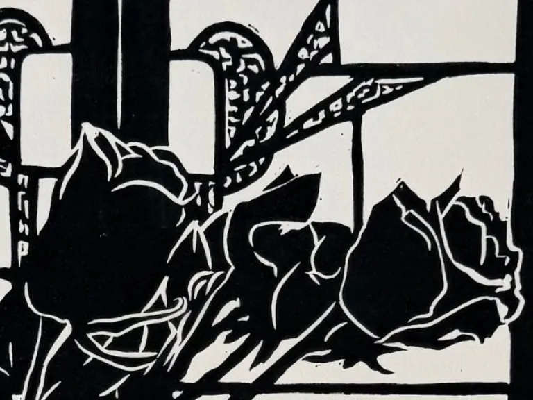 A black-and-white print depicting a cluster of arrange roses placed in front of a window with decorative panes.
